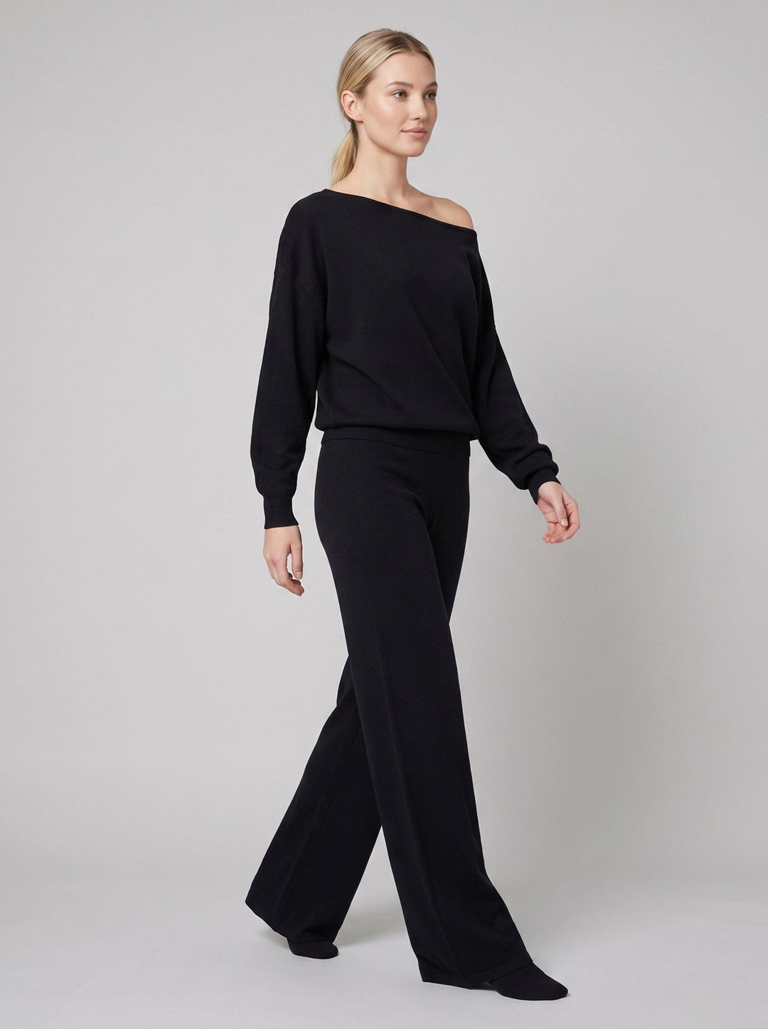 Luxe Eleganza loungewear set in black, off-shoulder knit sweater and wide-leg pants on model