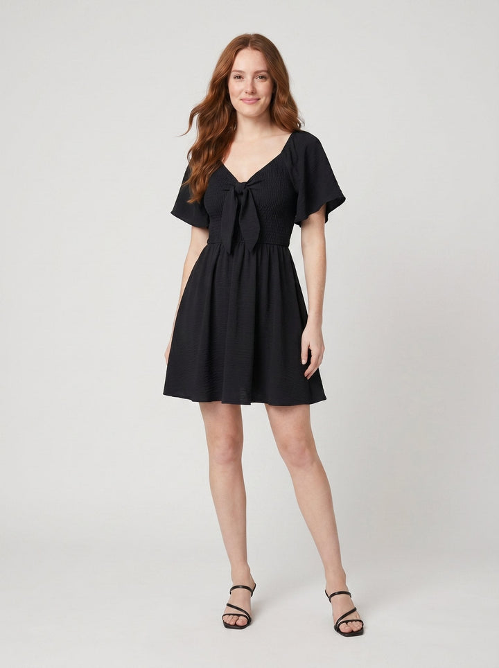 Vera V-neck bow tie mini dress black on model